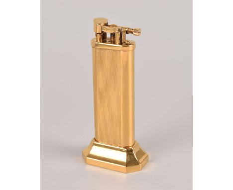 A gold plated Dunhill table lighter, on octagonal weighted base, no. 18989, with ribbed and smooth body, presented in a grey 