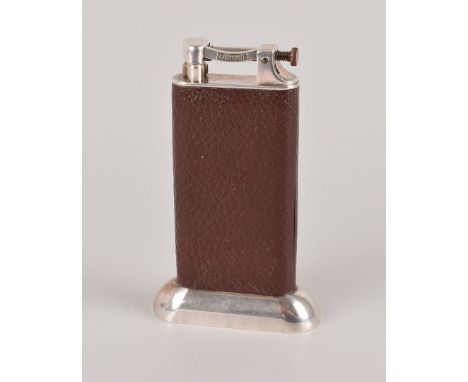 A Dunhill chrome and leather table lighter, having brown leather grip on weighted base, marked Dunhill to lifting extinguishe