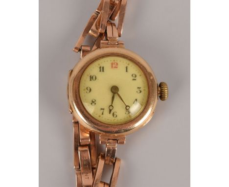 An early 20th century Rolex 15ct gold lady’s wristwatch, the trench style case with enamel dial, marked to movement, on expan