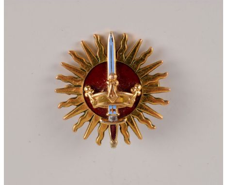 A fine 9ct gold and enamel heraldic emblem brooch from Garrard & Co, the sunburst shaped mount having red enamel to centre wi