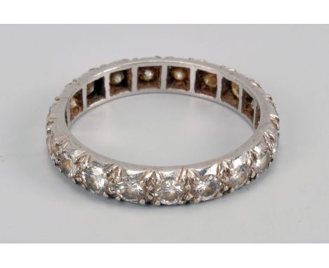 A vintage platinum and diamond full eternity ring, having brilliant cuts in mounted with engraved rims, two stones chipped, a