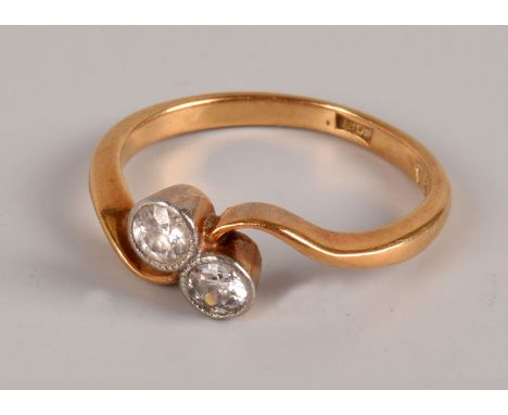 An Art Deco period two stone diamond ring, in 18ct gold crossover style mount with a pair of old cuts, approx 2.4g and size L