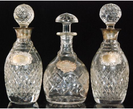 A pair of modern hallmarked silver collared clear glass decanters, Birmingham 1988 and another associated example each with s