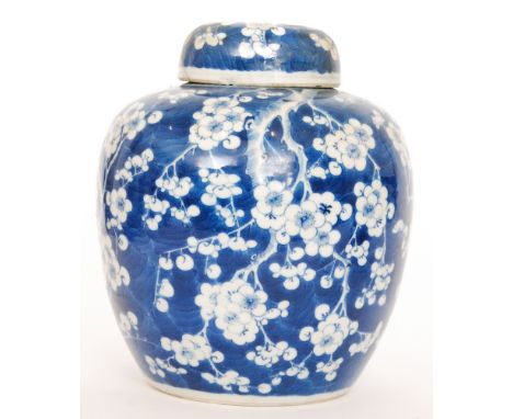A late 19th Century Chinese blue and white Prunus Blossom ginger jar and cover, bears painted Kangxi mark, height 26cm, A/F