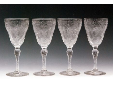 A set of four early 20th Century Thomas Webb & Sons clear crystal wine glasses, the conical bowl intaglio cut with a ribbon b