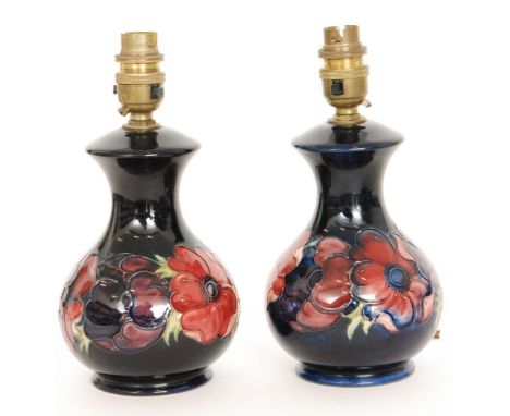 A pair of Moorcroft Pottery lamp bases decorated in the Anemone pattern with tubelined flowers against a blue wash ground, im