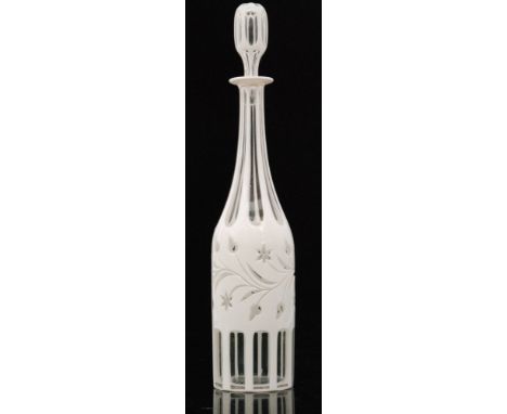 A large early 20th Century Bohemian glass decanter of slender bottle form cased in opal over clear crystal decorated with sli