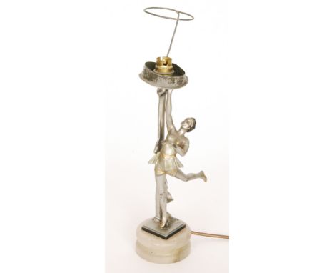 An Art Deco spelter table lamp modelled as a dancing girl with her right hand raised to support lamp fitting, all to a circul