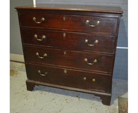 A George III mahogany chest of four long graduated drawers, brass loop drop handles on bracket feet below an ebonised moulded