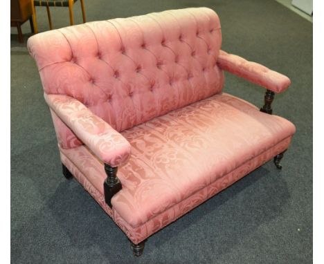 A Victorian two seat sofa, the mahogany frame with turned capitals and front legs, with pink button down upholstery, width 10