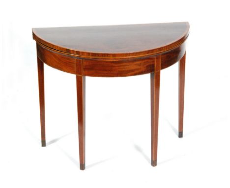 A George III mahogany and satinwood cross banded demi-lune fold-over card table on square tapering legs, width 91cm