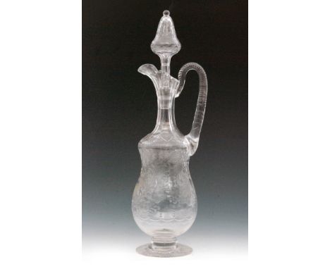 A large early 20th Century Stevens & Williams clear crystal glass claret jug, the spread foot rising to the double gourd form