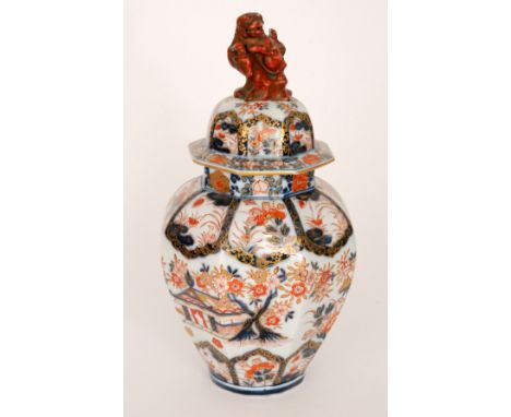 A 20th Century Chinese export hexagonal jar and cover decorated with flowers and foliage above a temple type building, all in