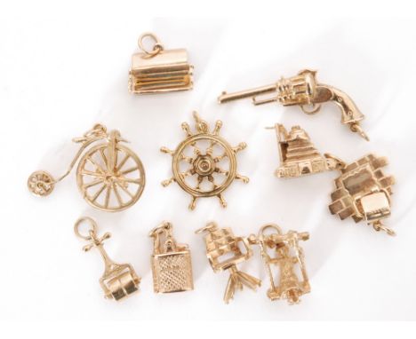 Ten assorted 9ct hallmarked charms to include a camera, chair, ship's wheel, penny farthing, revolver etc, total weight 26.5g