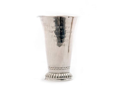 A hallmarked silver Keswick silver beaker of plain tapering form with wave border decoration to the base and fluted collet fo