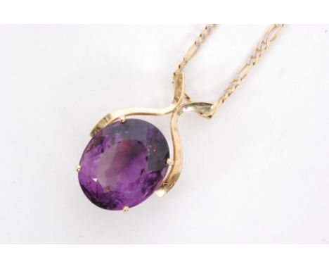 A modern 18ct amethyst pendant, the oval mixed cut amethyst claw set to a scroll frame suspended from a 9ct fancy link chain.
