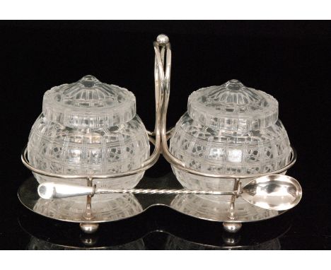 A pair of 20th Century crystal glass preserve jars of globular form, decorated with a mitre cut grid, to a silver plated stan