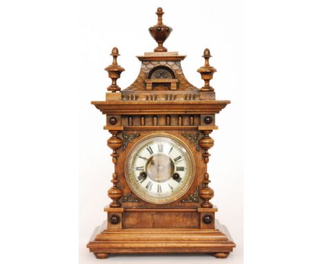 A late 19th Century walnut cased mantle clock with German movement, height 45cm.
