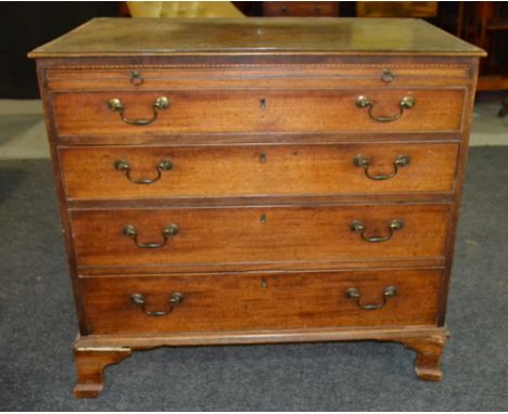 A 19th Century mahogany chest of four long drawers, with inlaid shell paterae to the top, above a brushing slide and raised t