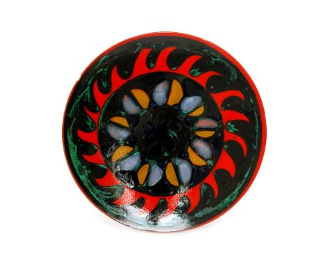 A Poole Pottery shape 5 Delphis charger decorated with a central stylised abstract roundel with a bright red wavy border agai