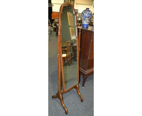 A 20th Century cheval mirror of arched form, the turned supports with finial mounts.