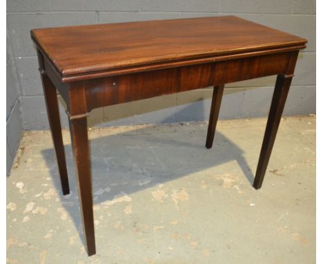 A 19th Century mahogany fold-over card table of rectangular form, raised to square tapered legs, width 92cm, S/D.