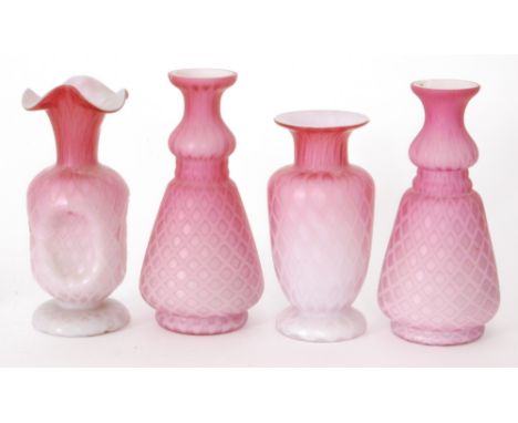 A group of late 19th Century satin quilted air trap glass comprising a pair of tapered form vases with waisted necks, a foote