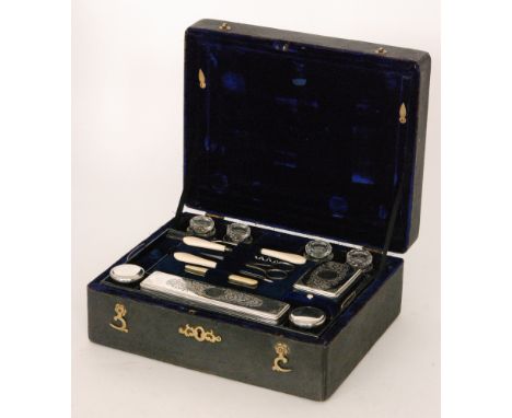 An early 19th Century shagreen dressing table case with blue plush interior fitted with plated jars and tools, width 30cm