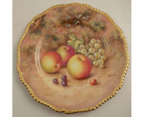 A Royal Worcester cabinet plate, decorated with fruit to a mossy background by Freeman, with shaped gilt edge, diameter 10.75