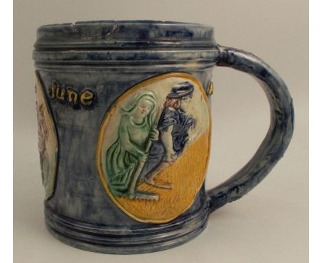 An Edward Bingham Castle Hedingham pottery tankard, decorated in relief with three roundels depicting figures and Avril, May 
