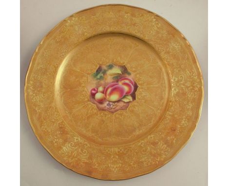 A Royal Worcester plate, decorated with a hand painted fruit centre by Henry, to an acid gilt border, diameter 11ins -&nbsp;G
