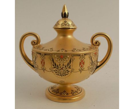 A Royal Worcester two handled urn shape vase and cover, with gold ground decorated in black, red and white, shape number 2742