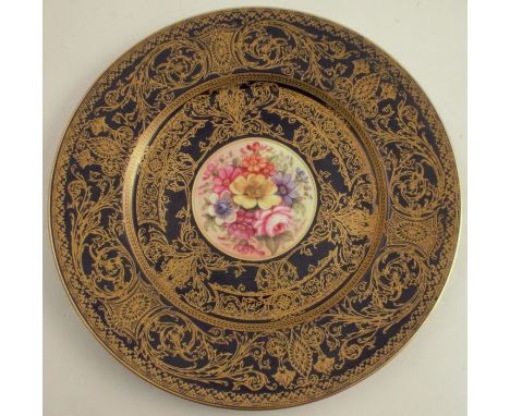 A Royal Worcester cabinet plate, decorated with flowers to the centre by Freeman, with blue and gilt border, diameter 10.5ins