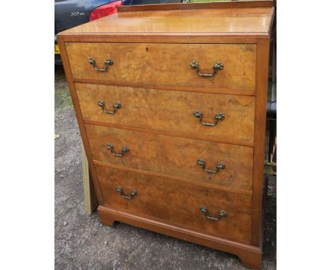 A 20th century walnut chest, of four long drawers, raised on bracket feet, width 31ins, depth 18.5ins, height 41.5ins