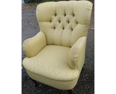 A modern upholstered easy chair, with button back, has fire labels&nbsp;