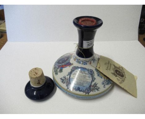 A sealed Wade porcelain Nelson's ship decanter, top damaged, containing British Navy Pussers Rum,&nbsp;