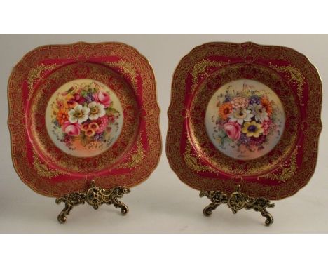 A pair of Royal Worcester square plates, decorated with flowers by Earnest Barker, to a red and gilt border, dated 1929, widt