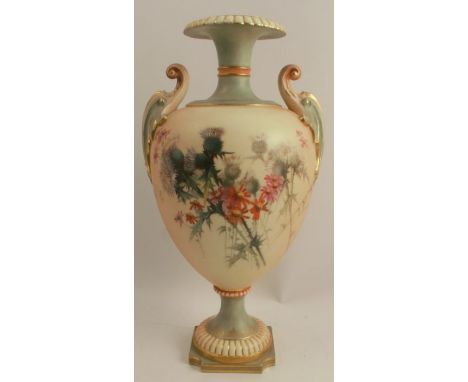 A Royal Worcester blushed ivory two handled vase, raised on a pedestal, decorated with thistles and flowers to a blushed ivor