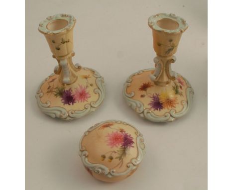 A pair of Grainger's Worcester blush ivory dressing table candlesticks, decorated with flowers and a cobweb with turquoise bo