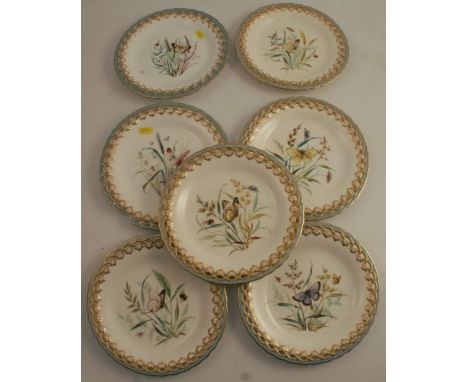 A set of seven 19th century Worcester dessert plates, decorated with flowers and insects, with pierced turquoise border, some