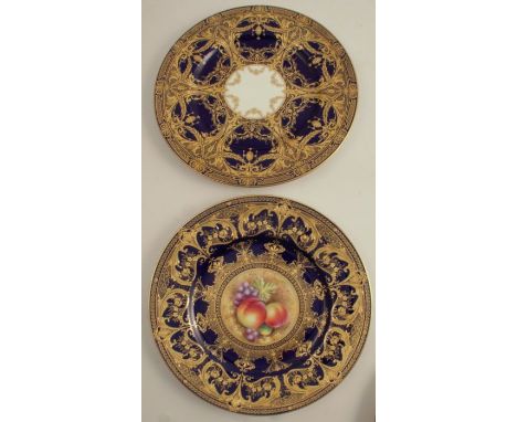 A Royal Worcester plate, decorated with a central panels of fruit by Leaman, to a blue and gilt ground, diameter 10.5ins, tog