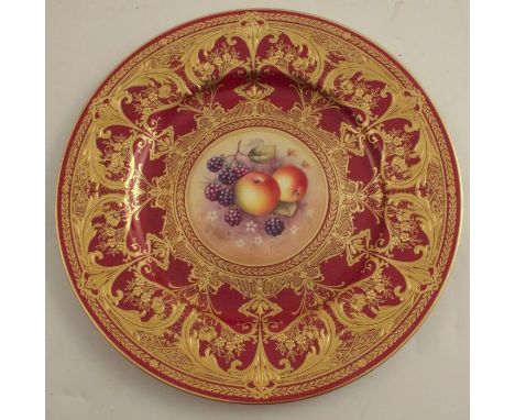 A Royal Worcester cabinet plate, decorated with fruit to the centre by P Lynes, with burgundy and gilt border, diameter 10.5i