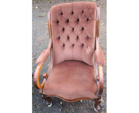 A 19th century mahogany and upholstered easy chair, with button back and scroll arms, raised on cabriole front supports