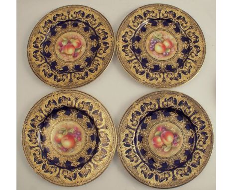 Four Royal Worcester plates, decorated with a central panel of hand painted fruit by Leaman, to a richly gilded blue border, 