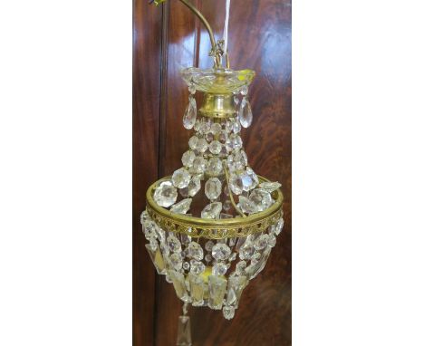 A gilt metal and glass chandelier light fitting, having tiered droppers