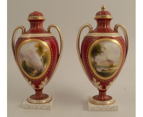 A pair of Royal Worcester covered vases, decorated with landscape panels in the Corot style by Harry Davis, to a red ground, 