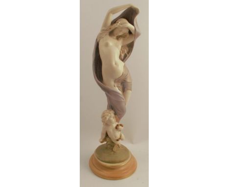A Royal Worcester figure, decorated in shot silk of a semi naked female and a cherub, model number 1819, dated 1909, height 2