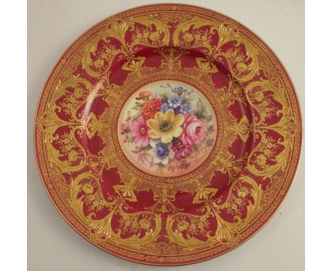 A Royal Worcester cabinet plate, decorated with flowers to the centre by Freeman, with burgundy and gilt border, diameter 10.