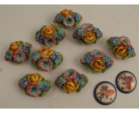 A set of nine Royal Worcester flower ornaments, with gilt metal mounts to the back, together a pair of porcelain circular pla