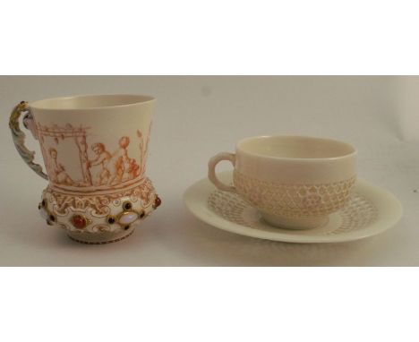 A 19th century Worcester porcelain mug, decorated with putti in sepia, with embossed band below and set with stones, marked E
